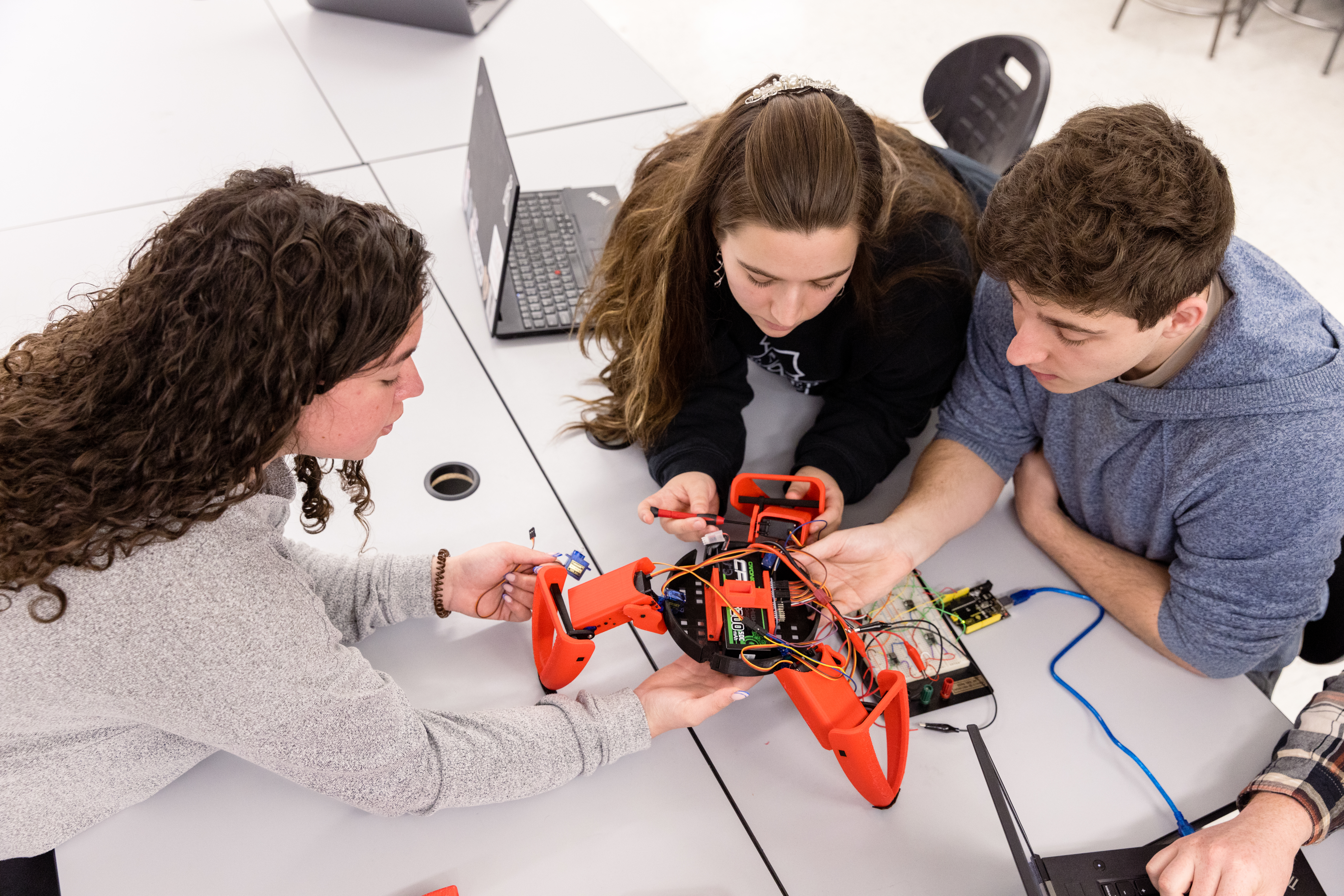 Photo of Students working on a drone